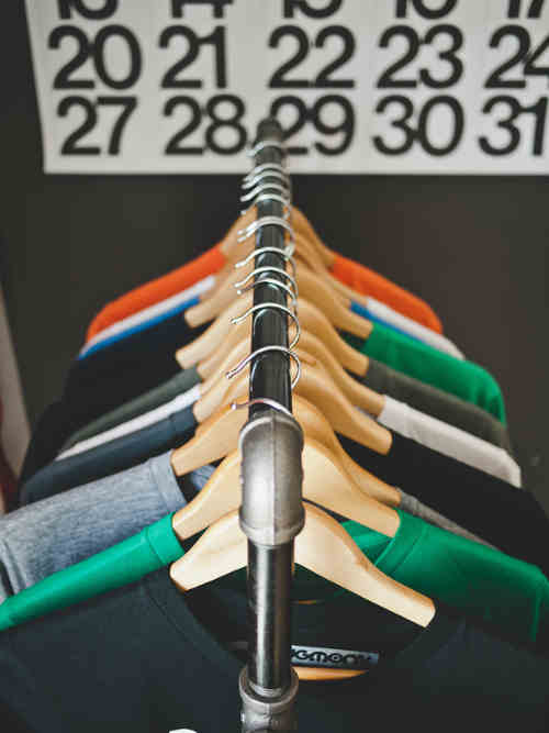 A rack of colorful sweaters on display for sale