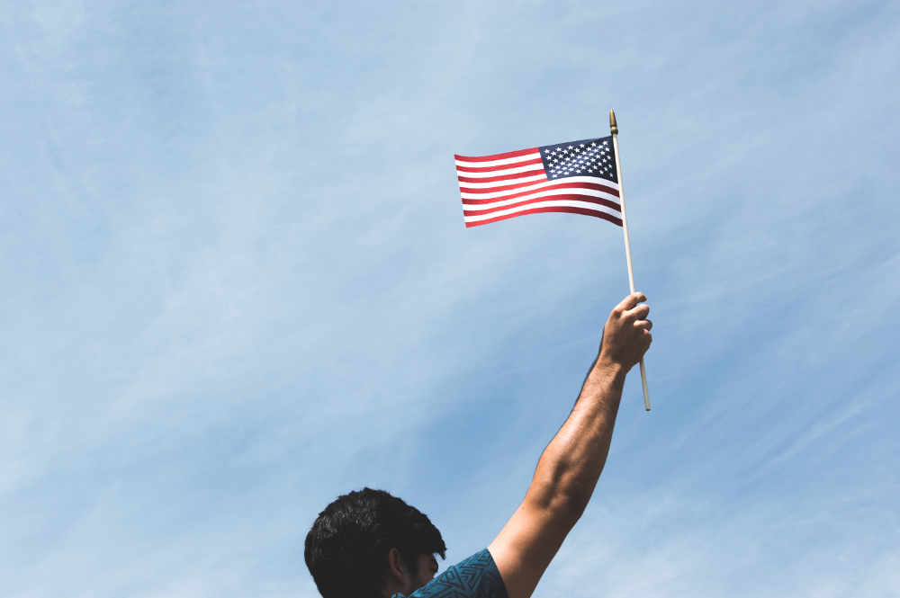 A man holding a miniature American flag